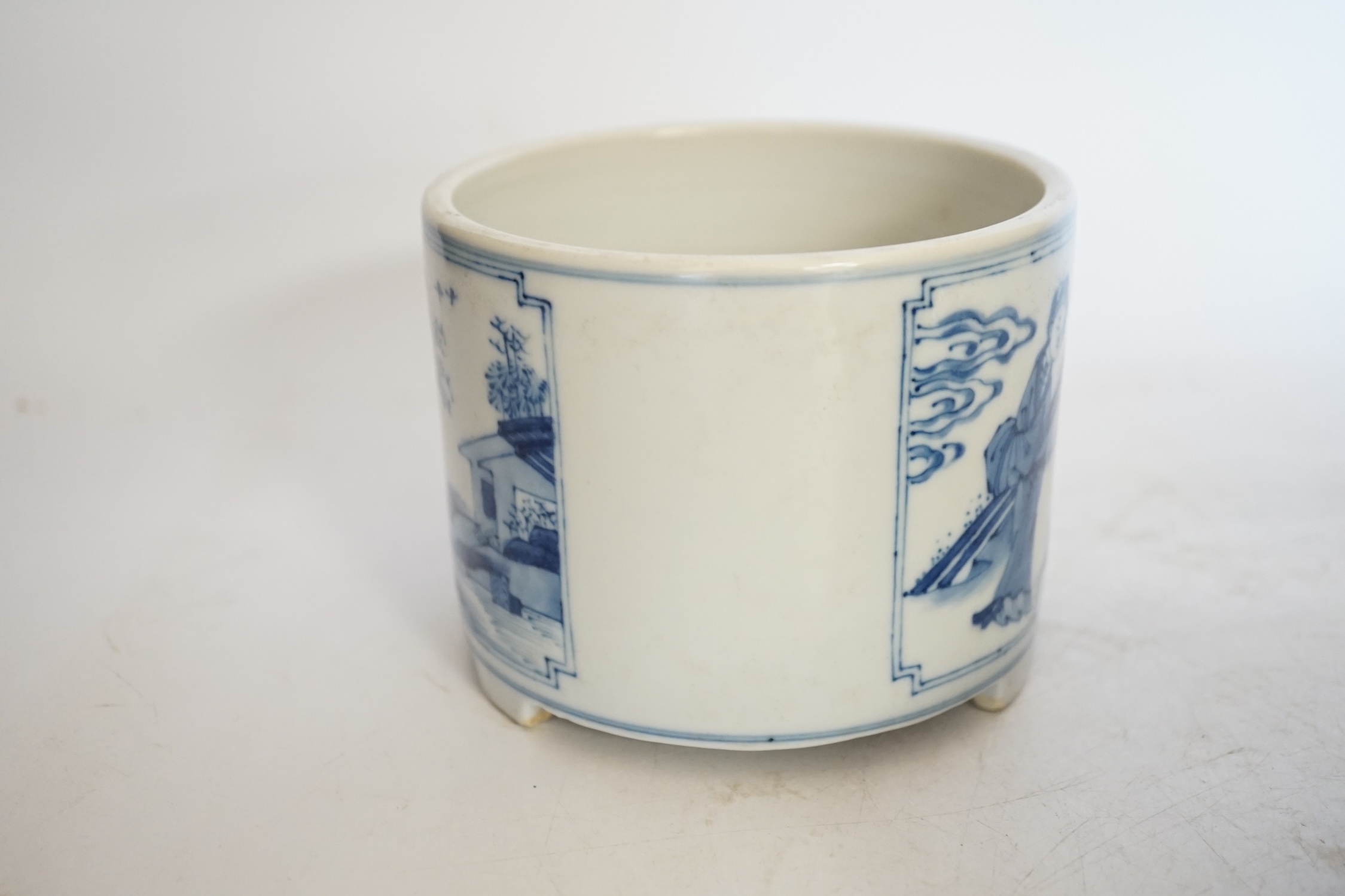 A Chinese blue and white footed brushpot and celadon glazed ‘fish’ bowl, tallest 9cm. Condition - good